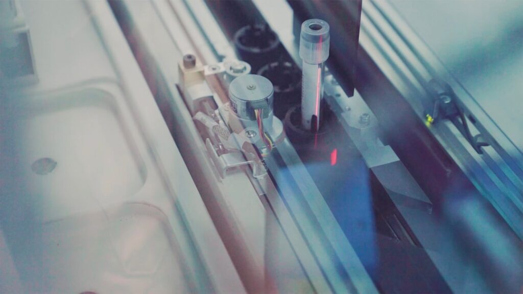 Laboratory. Tube (vial) with body material being transported on a track to analyzer in large Dutch lab.