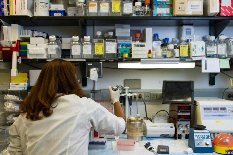 Chanelle Case Borden, Ph.D., a postdoctoral fellow in the National Cancer Institute's Experimental Immunology Branch, pipetting DNA samples into a tube for polymerase chain reactio